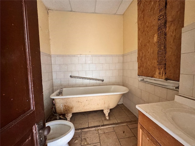 5168 Vernon Ave, Saint Louis, MO 63113 - full bathroom with tile walls, a soaking tub, vanity, wainscoting, and tile patterned floors