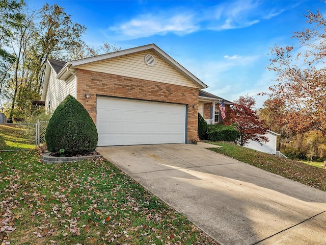 2352 Brookview Dr, Washington, MO 63090 - view of front of house with brick siding, an attached garage, and driveway