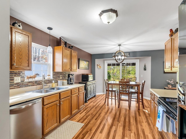 2352 Brookview Dr, Washington, MO 63090 - kitchen with black appliances, a sink, light countertops, a chandelier, and tasteful backsplash