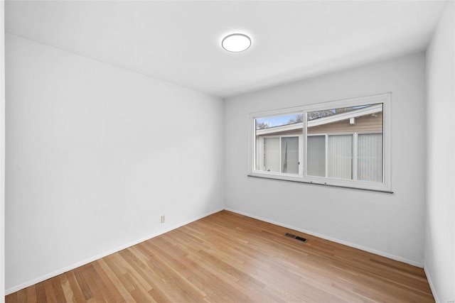 unfurnished room featuring light wood-style floors and baseboards