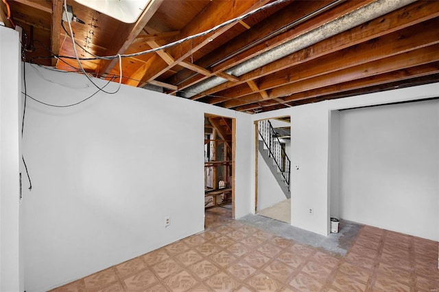 finished basement with stairway and light floors