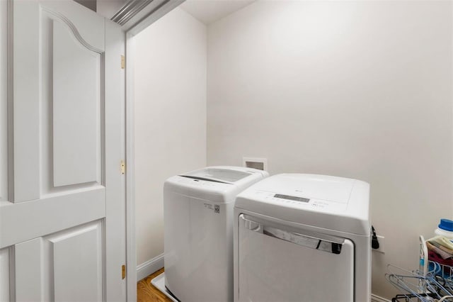 clothes washing area with washing machine and dryer