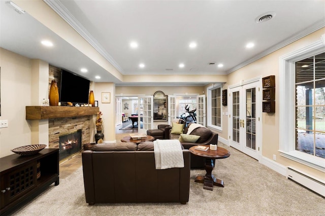 living area featuring french doors, a baseboard heating unit, ornamental molding, carpet floors, and a stone fireplace