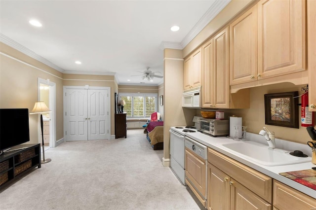 kitchen with a sink, white appliances, light carpet, baseboards, and light brown cabinets