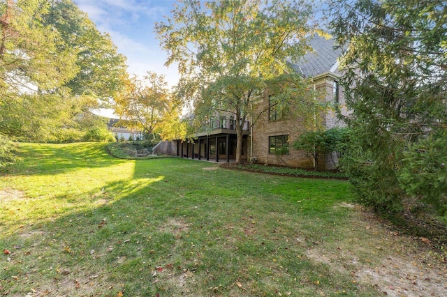 view of grassy yard featuring a deck
