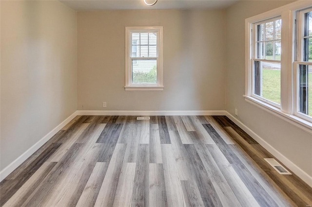 empty room featuring dark wood finished floors and baseboards