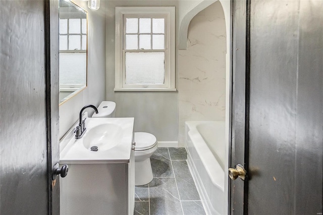 bathroom featuring toilet, vanity, a bathtub, baseboards, and a shower