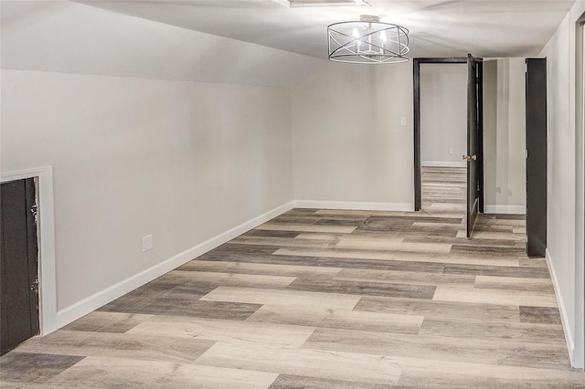 basement featuring wood finished floors and baseboards