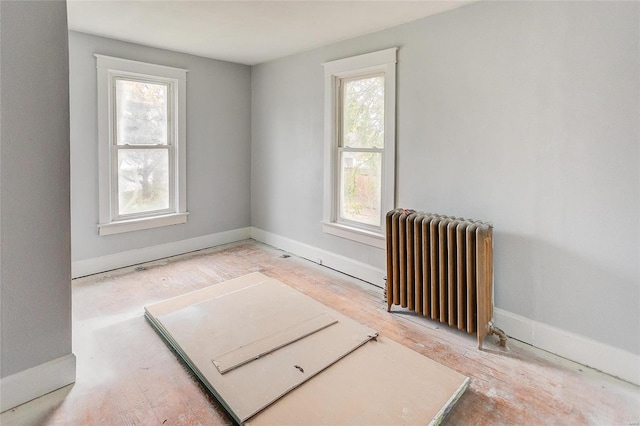 124 Carlyle Ave, Belleville, IL 62220 - empty room with radiator heating unit, baseboards, and wood finished floors