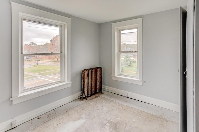 124 Carlyle Ave, Belleville, IL 62220 - unfurnished room with radiator heating unit, healthy amount of natural light, and baseboards