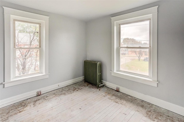 124 Carlyle Ave, Belleville, IL 62220 - unfurnished room featuring radiator, wood finished floors, and baseboards