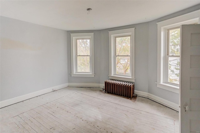 124 Carlyle Ave, Belleville, IL 62220 - empty room with radiator, healthy amount of natural light, and baseboards