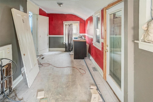 bathroom featuring lofted ceiling and baseboards