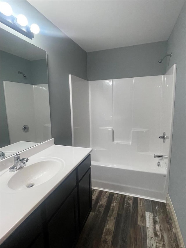 45 Wedgewood Dr, Union, MO 63084 - bathroom featuring wood finished floors, shower / bath combination, vanity, and baseboards