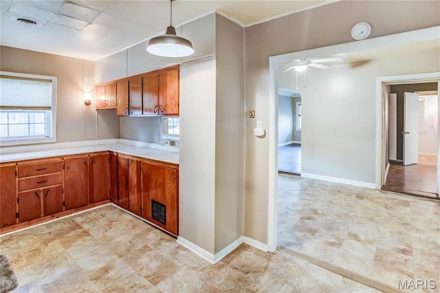 219 Highland St, Carrollton, IL 62016 - kitchen featuring light countertops, brown cabinetry, and plenty of natural light