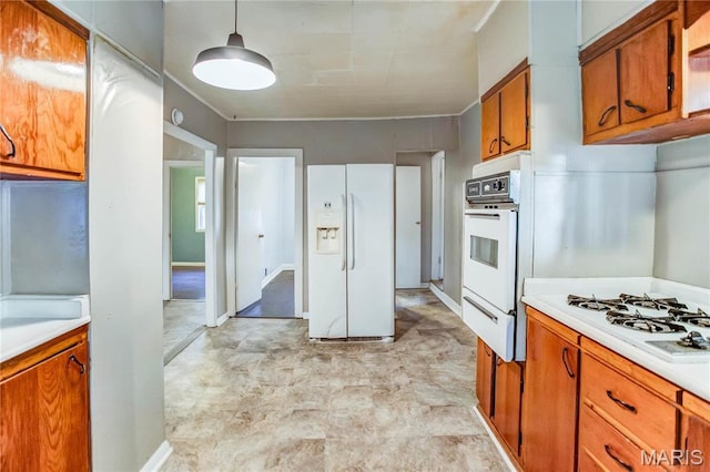 219 Highland St, Carrollton, IL 62016 - kitchen with white appliances, brown cabinetry, light countertops, a warming drawer, and decorative light fixtures