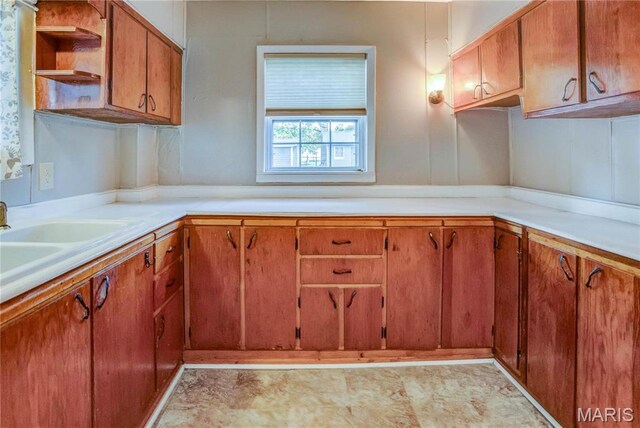 219 Highland St, Carrollton, IL 62016 - kitchen featuring open shelves, brown cabinetry, light countertops, and a sink
