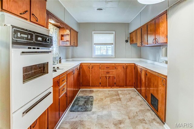 219 Highland St, Carrollton, IL 62016 - kitchen featuring oven, brown cabinets, and light countertops