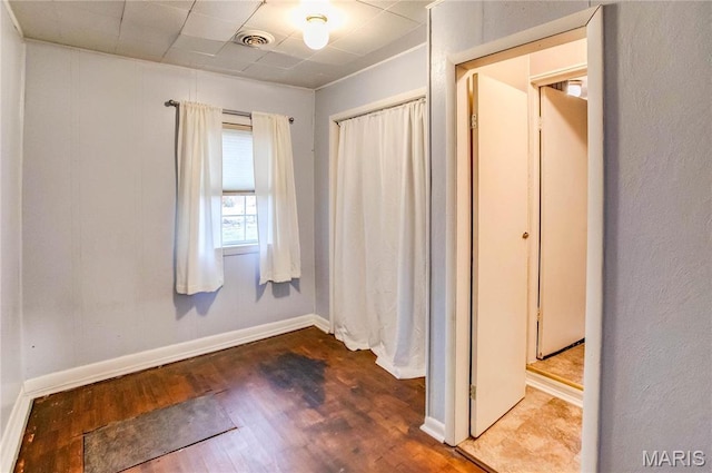 219 Highland St, Carrollton, IL 62016 - unfurnished bedroom with dark wood-type flooring, baseboards, and a closet