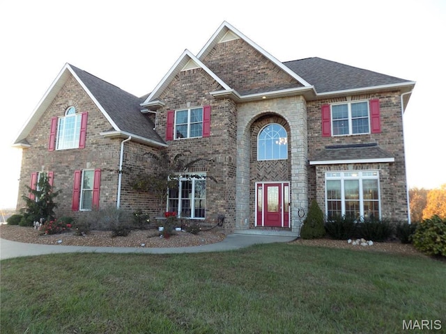 13185 Jenna Ln, Rolla, MO 65401 - traditional-style house featuring a front yard, a shingled roof, and brick siding
