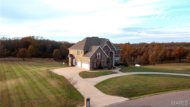 13185 Jenna Ln, Rolla, MO 65401 - view of property exterior featuring concrete driveway, stone siding, an attached garage, a yard, and a forest view