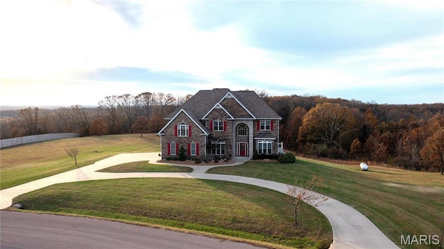 13185 Jenna Ln, Rolla, MO 65401 - view of front of property featuring curved driveway, a front yard, and a wooded view