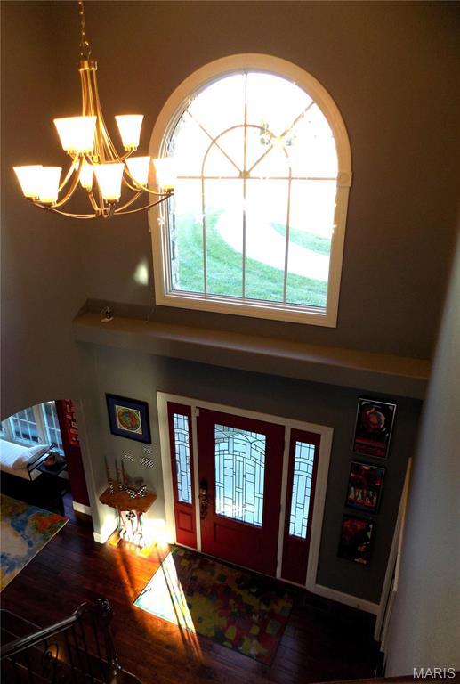 13185 Jenna Ln, Rolla, MO 65401 - foyer with a chandelier, wood finished floors, and a towering ceiling