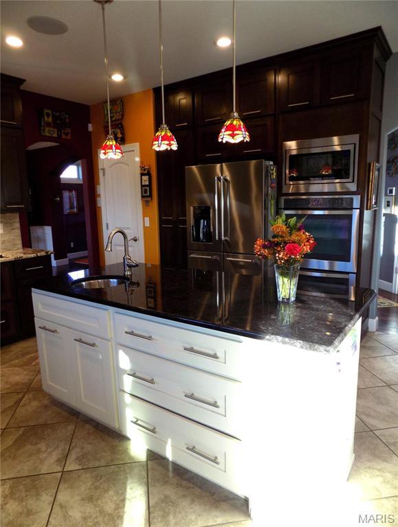 13185 Jenna Ln, Rolla, MO 65401 - kitchen featuring appliances with stainless steel finishes, a sink, light tile patterned floors, dark stone countertops, and recessed lighting