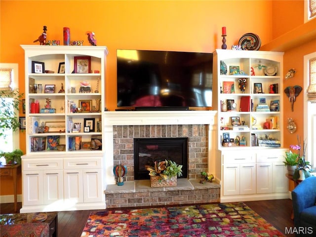 13185 Jenna Ln, Rolla, MO 65401 - living room featuring dark wood finished floors and a brick fireplace