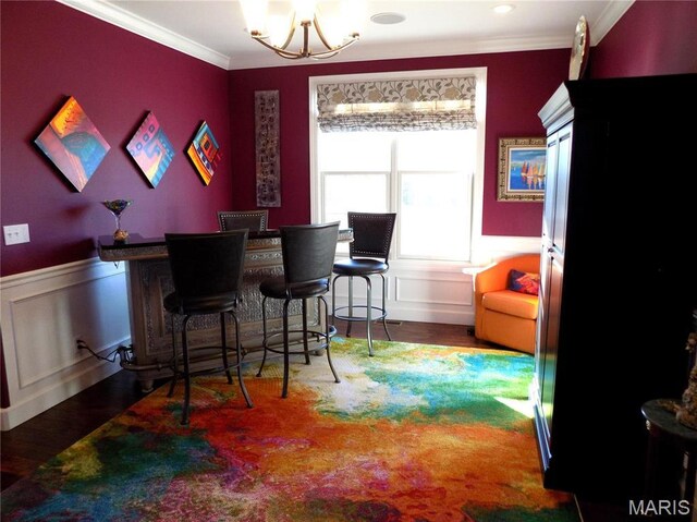 13185 Jenna Ln, Rolla, MO 65401 - bar featuring a chandelier, wood finished floors, ornamental molding, and a wainscoted wall