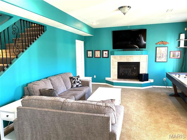 13185 Jenna Ln, Rolla, MO 65401 - carpeted living room featuring stairway, a tiled fireplace, and baseboards