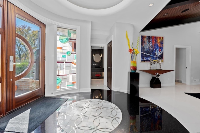 foyer entrance featuring recessed lighting and baseboards