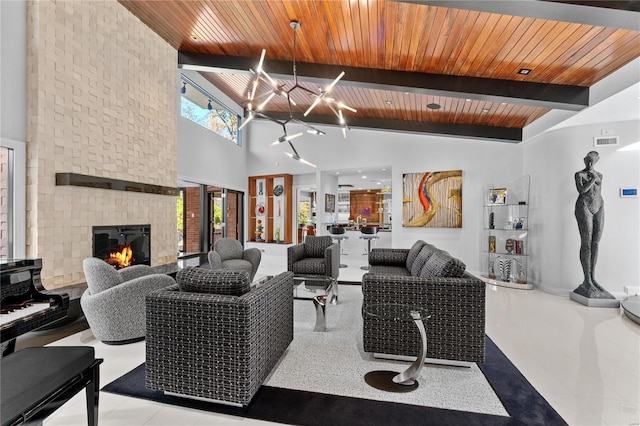 living room with wood ceiling, beam ceiling, a large fireplace, tile patterned floors, and high vaulted ceiling