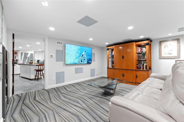carpeted living room with recessed lighting and baseboards