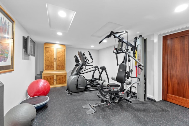 exercise room with recessed lighting and baseboards