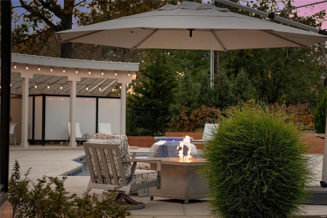 view of patio / terrace with an outdoor fire pit and fence