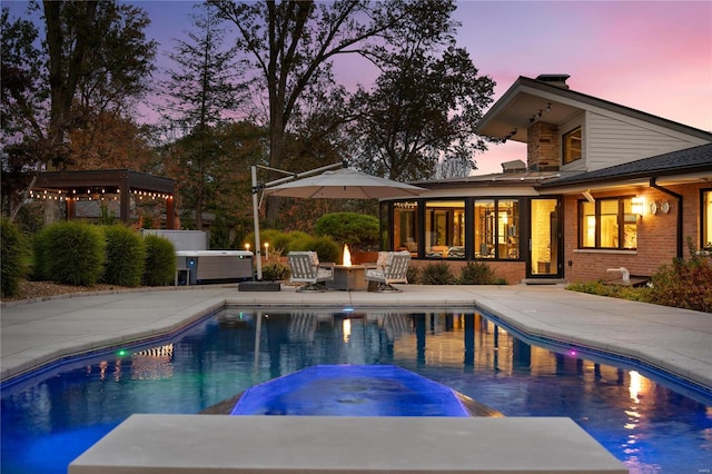 view of pool with a patio and a pool with connected hot tub