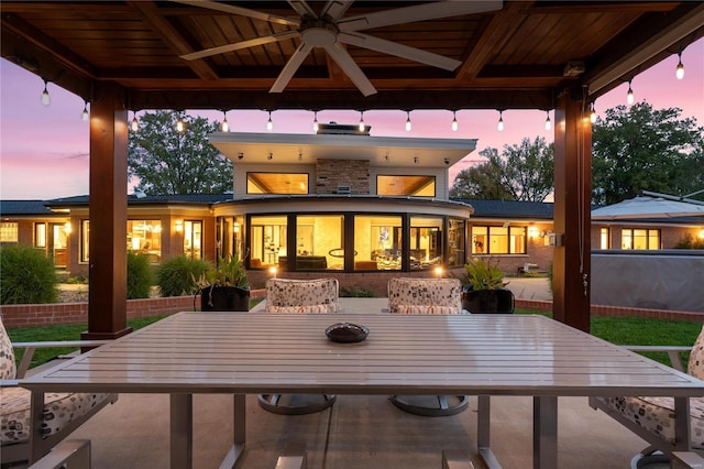 back of property featuring a gazebo, outdoor dining area, and a ceiling fan