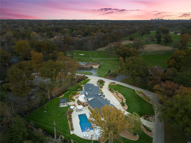 aerial view at dusk of view of pool