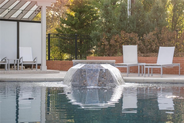 view of swimming pool with a patio and fence