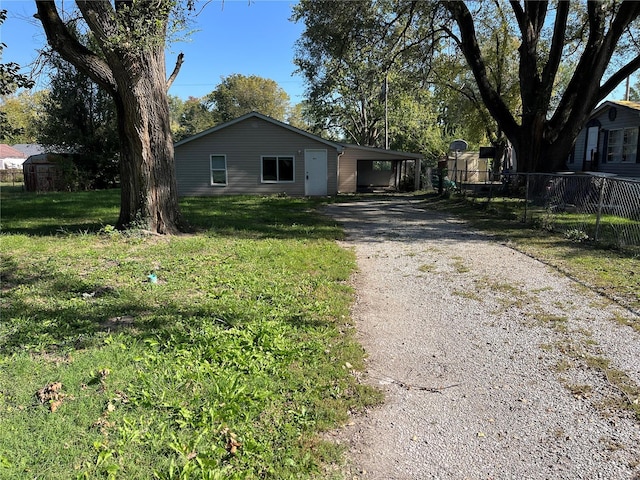 ranch-style house with asphalt driveway and an attached carport