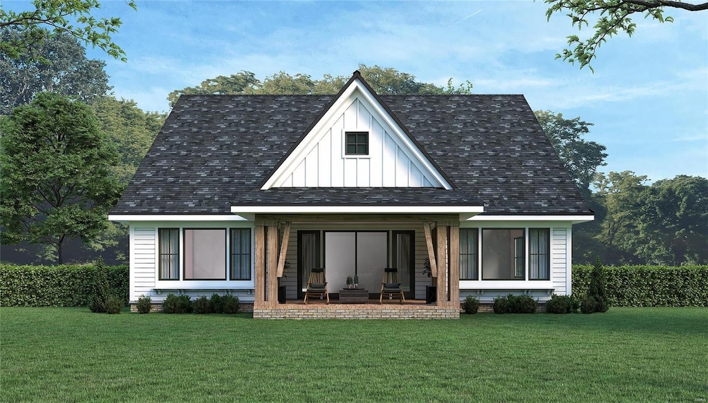 2601 E Ave, Wildwood, MO 63040 - rear view of property with board and batten siding and a yard