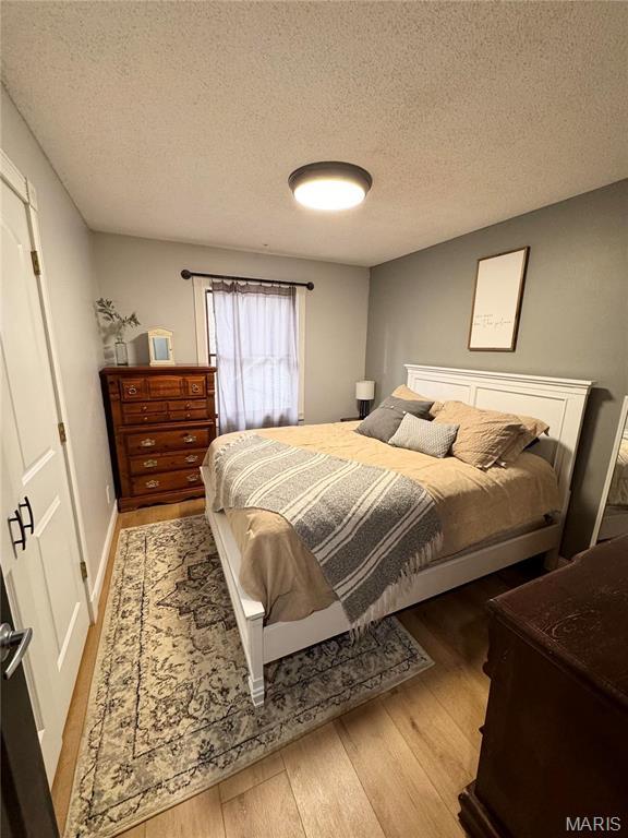 62812 Brown Ests, Hannibal, MO 63401 - bedroom with wood finished floors and a textured ceiling