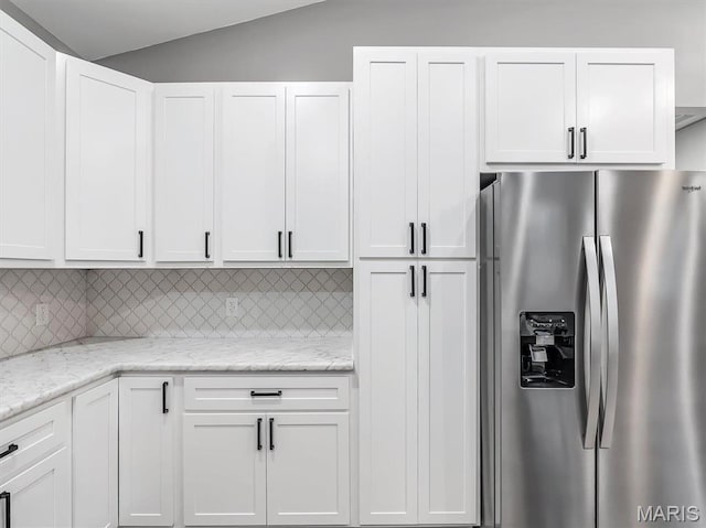 60 Cedar Brook Dr, Pacific, MO 63069 - kitchen with stainless steel fridge with ice dispenser, tasteful backsplash, white cabinets, and lofted ceiling