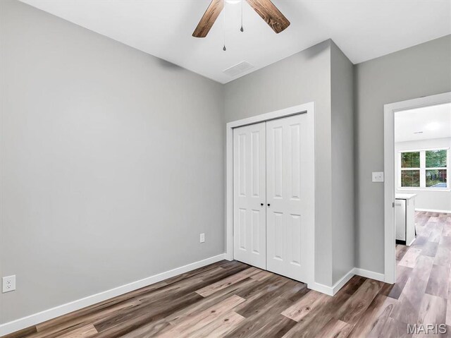60 Cedar Brook Dr, Pacific, MO 63069 - unfurnished bedroom featuring wood finished floors, a closet, and ceiling fan
