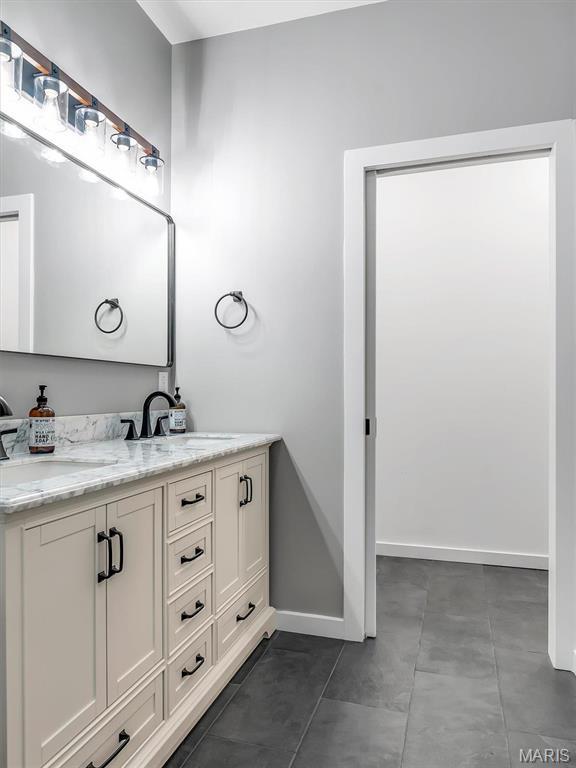 60 Cedar Brook Dr, Pacific, MO 63069 - bathroom featuring double vanity and baseboards