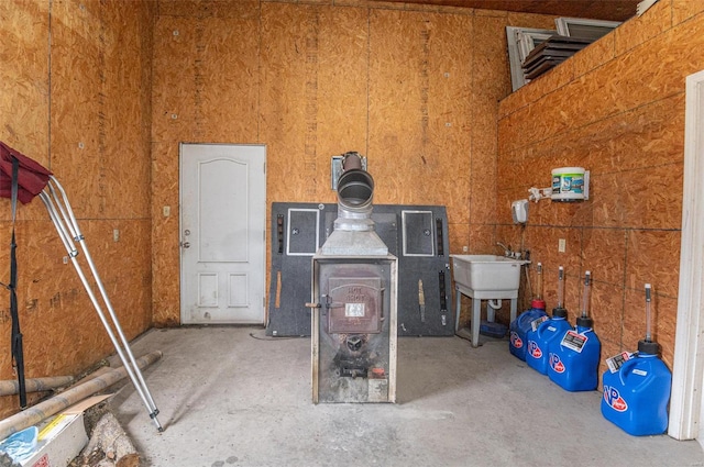 miscellaneous room with a wood stove and a towering ceiling