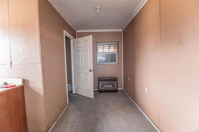corridor featuring heating unit, concrete floors, and ornamental molding