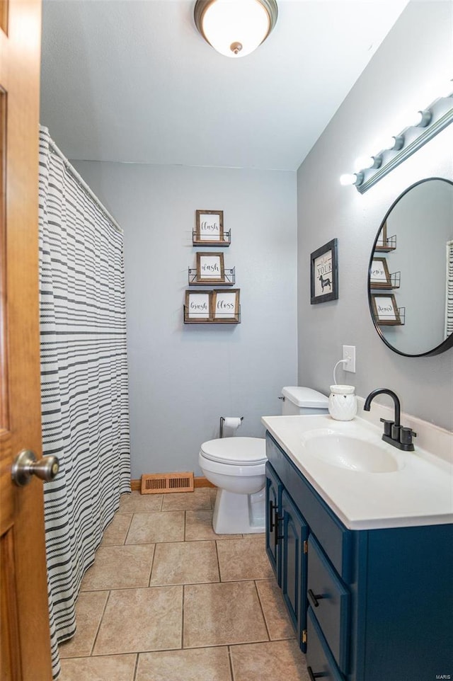 full bathroom with vanity, toilet, and tile patterned flooring