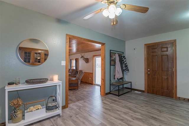 entryway with wood finished floors, ceiling fan, and baseboards